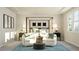 This bedroom features a stylish canopy bed, sitting area, and windows that let in ample natural light at 2968 Hanging Valley Way, Wake Forest, NC 27587