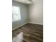 Light-filled bedroom with a window, neutral walls, and modern flooring at 3000 Centennial Woods Dr # 302, Raleigh, NC 27603