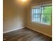 An ample room with a large window and new flooring provides light and space at 3000 Centennial Woods Dr # 302, Raleigh, NC 27603