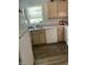 Bright kitchen with a window, white appliances, and wood cabinets at 3000 Centennial Woods Dr # 302, Raleigh, NC 27603