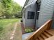 Charming gray home exterior with a well-maintained lawn and lovely stone paver pathway at 306 Roebling Ln, Cary, NC 27513
