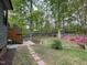 Backyard with wooden deck, landscaping, a stone creek bed, privacy fence, and plenty of space at 306 Roebling Ln, Cary, NC 27513