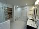 Bright bathroom featuring a double vanity, glass enclosed shower, and open shelving at 306 Roebling Ln, Cary, NC 27513