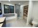 Bathroom with tub and shower, window and a custom storage nook at 306 Roebling Ln, Cary, NC 27513
