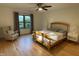 Bedroom featuring hardwood floors, a ceiling fan, and a comfortable chair near a window at 306 Roebling Ln, Cary, NC 27513