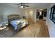 Bedroom with hardwood floors, ceiling fan, and walk-in closet with organized shelving at 306 Roebling Ln, Cary, NC 27513