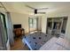 Bedroom with hardwood floors, ceiling fan, desk, and organized closet at 306 Roebling Ln, Cary, NC 27513