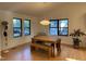 Cozy dining space with hardwood floors, modern lighting, and ample natural light from windows at 306 Roebling Ln, Cary, NC 27513
