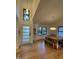 Bright dining room with modern light fixture, large windows, and stylish entry door at 306 Roebling Ln, Cary, NC 27513