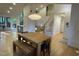Inviting dining area with a wooden table, bench seating, and ample natural light at 306 Roebling Ln, Cary, NC 27513