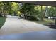 Long driveway leading to a home with a well-manicured front yard and lush landscaping at 306 Roebling Ln, Cary, NC 27513