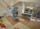 Open-concept living room with hardwood floors, modern furnishings, and sun-filled windows at 306 Roebling Ln, Cary, NC 27513