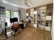 Inviting home office with hardwood floors, custom built-in shelving, and a modern desk setup with great lighting at 306 Roebling Ln, Cary, NC 27513
