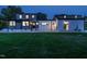 Backyard view of a two-story home at dusk, showcasing ample green space and exterior lighting at 316 Barbour St, Clayton, NC 27520
