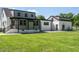 Expansive backyard view of the renovated home with manicured lawn and modern exterior at 316 Barbour St, Clayton, NC 27520