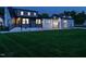 Evening view of the home's backyard, featuring updated exterior and manicured lawn at 316 Barbour St, Clayton, NC 27520