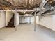 Unfinished basement featuring stairs, white walls, metal beams, and concrete flooring at 316 Barbour St, Clayton, NC 27520