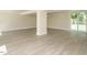 Open basement with wood floors, bright walls, large windows, and a sliding glass door at 316 Barbour St, Clayton, NC 27520