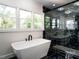 Modern bathroom features a soaking tub, black accents, and a luxurious glass shower at 316 Barbour St, Clayton, NC 27520