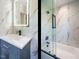 Modern bathroom featuring a vanity, illuminated mirror, glass shower, and marble walls at 316 Barbour St, Clayton, NC 27520