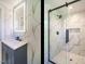 Modern bathroom featuring a vanity, mirror and glass shower with gold accents at 316 Barbour St, Clayton, NC 27520