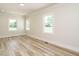 Bright bedroom featuring recessed lighting, wood floors, neutral paint, and large windows at 316 Barbour St, Clayton, NC 27520
