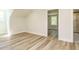 Bedroom featuring wood floors, white trim and walls, and view to new bathroom at 316 Barbour St, Clayton, NC 27520
