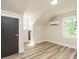 Bedroom featuring hardwood floors, two windows, and a black closet door at 316 Barbour St, Clayton, NC 27520