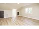 Bright bedroom with hardwood flooring, white walls, and multiple windows at 316 Barbour St, Clayton, NC 27520