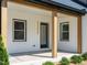 Inviting covered porch with natural wood accents and white painted brick exterior at 316 Barbour St, Clayton, NC 27520