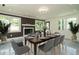 Bright dining room with a dining table, seating, fireplace, and large windows at 316 Barbour St, Clayton, NC 27520