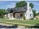Classic two-story home featuring a front porch, a well-kept lawn, and updated design at 316 Barbour St, Clayton, NC 27520