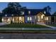 Beautiful two-story home with modern black-and-white design elements, illuminated for a warm evening glow at 316 Barbour St, Clayton, NC 27520