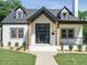 Attractive home with a modern glass door and well-maintained landscaping, inviting and stylish at 316 Barbour St, Clayton, NC 27520