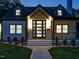 Elegant front entrance of a two-story home, highlighted with stylish exterior lighting at dusk at 316 Barbour St, Clayton, NC 27520