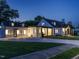 Charming two-story home, illuminated at dusk, showcasing its extended driveway and manicured lawn at 316 Barbour St, Clayton, NC 27520