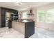 Modern kitchen features stainless steel appliances, a large island, and herringbone backsplash at 316 Barbour St, Clayton, NC 27520