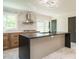 Stylish kitchen features a large island, herringbone backsplash, stainless steel range hood, and modern lighting at 316 Barbour St, Clayton, NC 27520