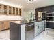 Bright kitchen features a large island, modern lighting, stainless steel appliances, and marble floors at 316 Barbour St, Clayton, NC 27520