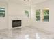 Cozy living room with fireplace, ample natural light, and elegant marble flooring at 316 Barbour St, Clayton, NC 27520