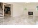 Bright open living room with fireplace, marble floors, staircase and kitchen view at 316 Barbour St, Clayton, NC 27520