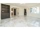 Bright living room showcasing built-in shelving, large windows, and marble floors at 316 Barbour St, Clayton, NC 27520
