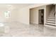 Open living room features staircase with tile flooring, lots of sunlight, and bright neutral colors at 316 Barbour St, Clayton, NC 27520
