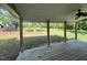 View from the covered back porch overlooking a spacious, well-maintained yard at 317 Brewer Rd, Louisburg, NC 27549