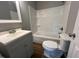 Bathroom featuring a single sink vanity, toilet, and shower-tub combo at 317 Brewer Rd, Louisburg, NC 27549