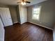 Cozy bedroom with hardwood floors, closet, and natural light at 317 Brewer Rd, Louisburg, NC 27549
