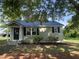Charming single-story home with a newly installed black metal roof and neatly landscaped front yard at 317 Brewer Rd, Louisburg, NC 27549