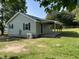 Rear view of house showing a covered porch with wood posts and black shutters on the windows at 317 Brewer Rd, Louisburg, NC 27549