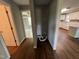 Hallway view featuring hardwood floors, and a glimpse into the kitchen and living room at 317 Brewer Rd, Louisburg, NC 27549