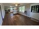 Open living area flowing into the kitchen with hardwood floors and a ceiling fan at 317 Brewer Rd, Louisburg, NC 27549